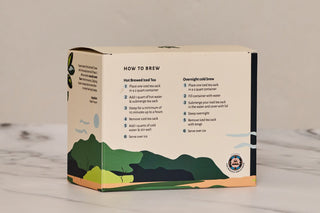 Brewing instructions for iced tea sacks. Product packaging with a scenic design on a marble surface